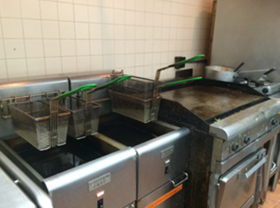Pictured (from left to right): A fryer and a stove, just part of all the equipment needed to serve 1500 people, 5 days a week