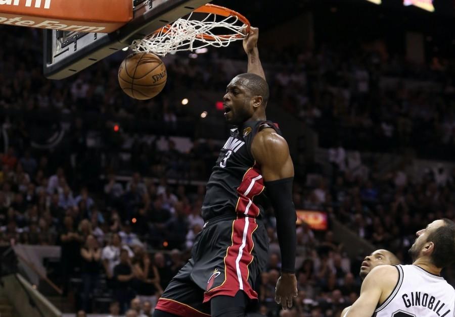 SAN ANTONIO, TX - JUNE 13:  Dwyane Wade #3 of the Miami Heat dunks the ball in front of Manu Ginobili #20 of the San Antonio Spurs in the fourth quarter during Game Four of the 2013 NBA Finals at the AT&T Center on June 13, 2013 in San Antonio, Texas. NOTE TO USER: User expressly acknowledges and agrees that, by downloading and or using this photograph, User is consenting to the terms and conditions of the Getty Images License Agreement.  (Photo by Christian Petersen/Getty Images)