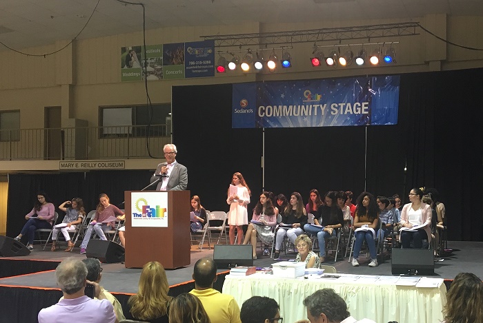 Scholastic coordinator Michael Bell introduces National Silver Key winter Melissa Benedek to read a poem from her portfolio entitled Cigarette Smoke.
