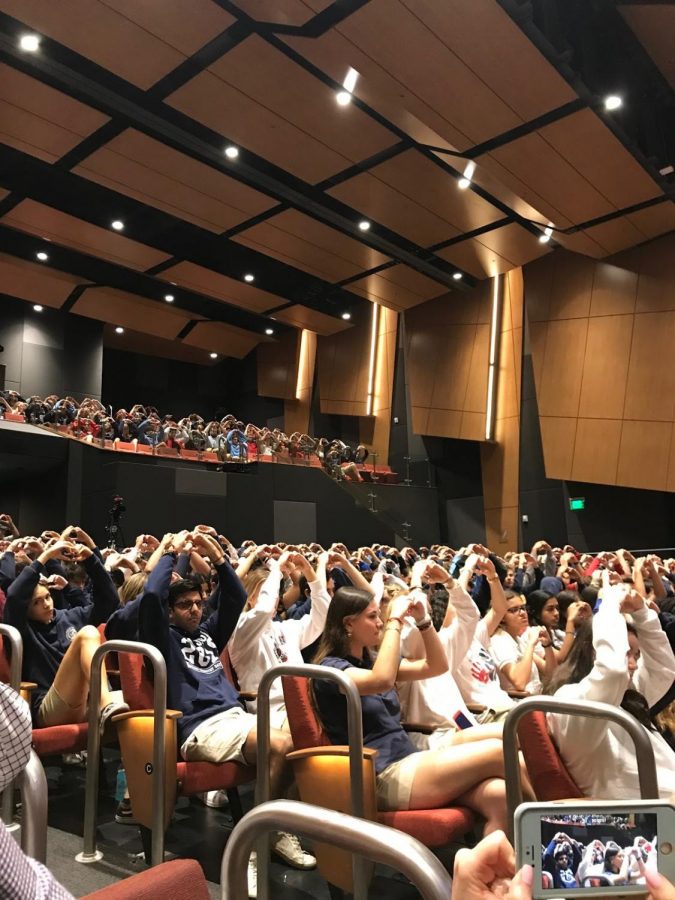 During a MOSS assembly, students raise their arms to give support to the 17 lives lost during the Parkland shooting. 