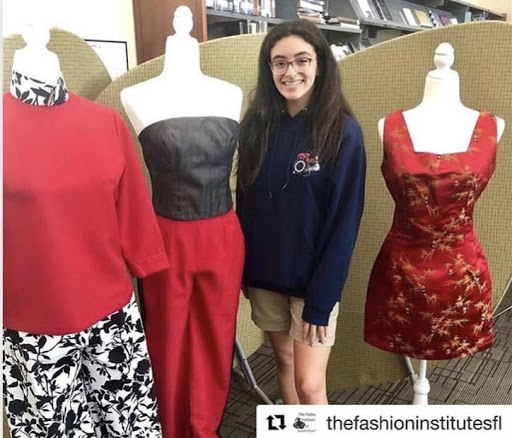 Posing with her own designs displayed in the Franco Center in 2019