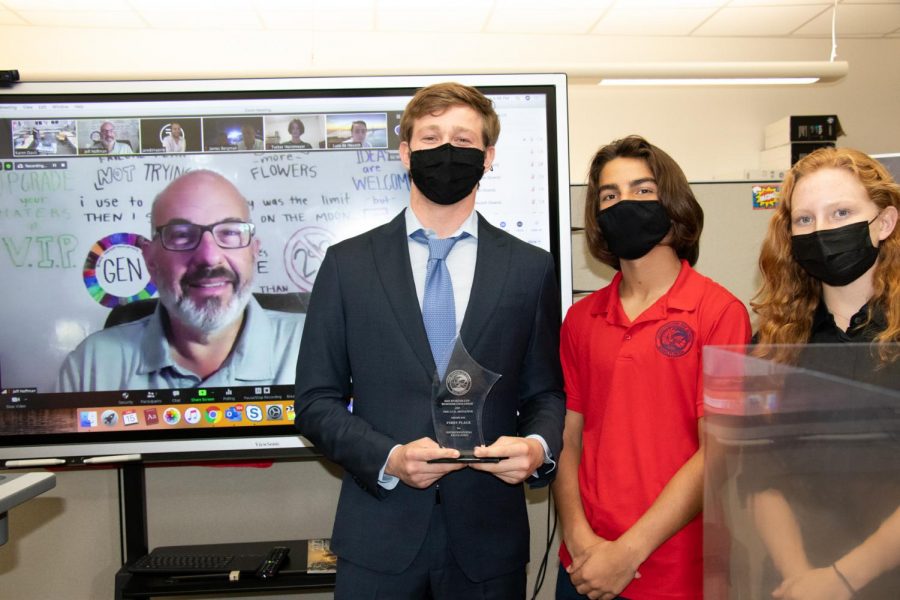 Spartan Cup – Winner Ben Malamed holds his trophy next to Beck Trafton of Clothy and Scout Hudson of CluttrFree.
Judge Jeff Hoffman, founder of priceline.com and Booking.com, is behind on the screen, along with Ben’s partner Tucker Horstmeyer and Beck’s partner Luca DeHeusch, who zoomed into the competition.